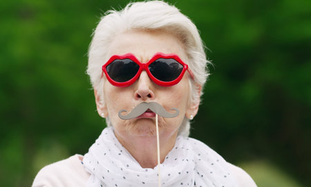 Lifes too short not to be a little silly. Portrait of a senior woman wearing fun glasses at the...