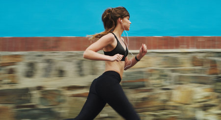 I didnt chose the running life, it chose me. an attractive young woman wearing gym wear and running...
