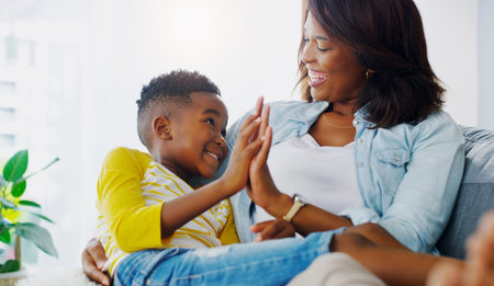Hand in hand through it all. a young mother bonding and spending time with her adorable little boy at home.の写真素材
