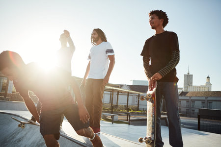 Were living life on the go. Full length shot of a group of friends skating together on their...