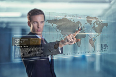 Global business at his fingertips. a handsome young businessman using a digital interface.