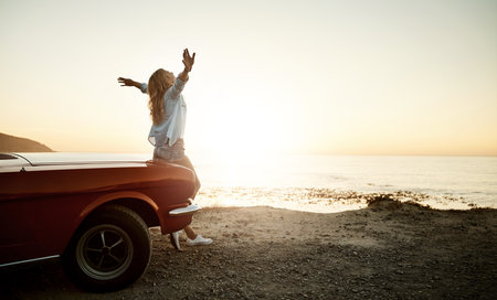 Say hello to beautiful adventures more often. a young woman enjoying a road trip along the coast.の写真素材