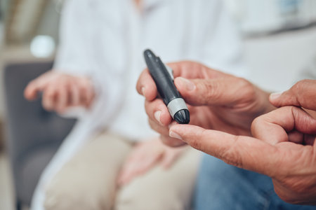 Finger, healthcare and diabetes with a senior man testing his blood sugar level while in his retirement home. Medical, wellness and test with a mature male using a glucometer to measure his glucoseの写真素材