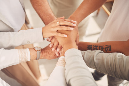 Business women, hands together and unity above in partnership or trust for teamwork, collaboration or support at office. Woman group piling hand in team building for cooperation, motivation or unionの写真素材