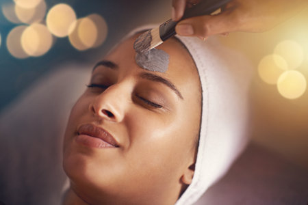 Dear skin, this is for you. a young woman enjoying a facial treatment at a spa.の写真素材