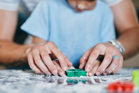 Shape their childhoods with love. a little boy baking with his father at home.の写真素材