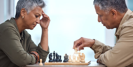 Strategy, moving and thinking with old couple and chess for bonding, competition and mental exercise. Relax, problem solving and smart with man and woman at home for board games, checkmate or contestの写真素材