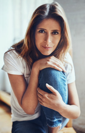 Relax. Youre on weekend time now. Portrait of an attractive young woman relaxing at home.の写真素材