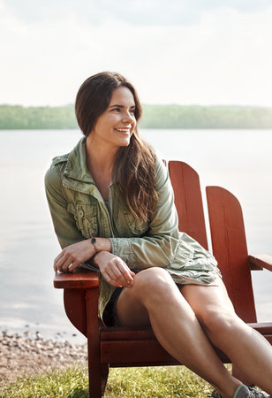 Welcome to my happy place. an attractive young woman relaxing at the lake.の写真素材