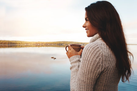 I think I found my happy place. an attractive young woman spending time alone by the lake.の写真素材