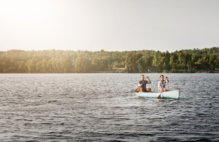 On course for relaxation. a young couple going for a canoe ride on the lake.の写真素材