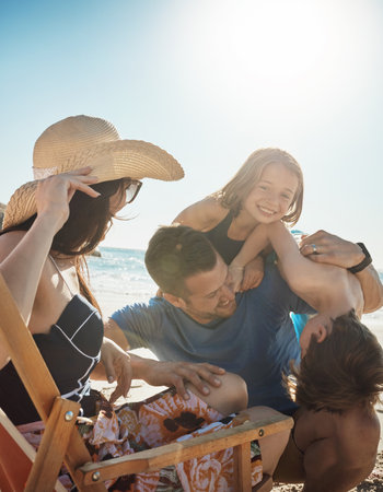 Childhood is short. Make theirs fun. a happy family of four having fun at the beach.の写真素材