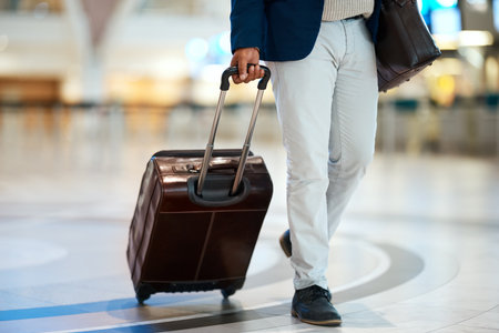 Airport, suitcase and black man travel for business opportunity, international career and immigration. Professional person or entrepreneur legs walking with luggage for flight, wealth and global jobの写真素材