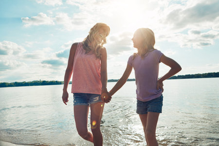Having some girl-on-girl time. a young woman and her daughter spending some quality time at the beach.の写真素材