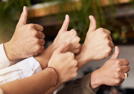 Thumbs up, winning and group of people thank you, support or teamwork hands for vote, yes or like emoji. Team building, target goals and winner women and men with business ok, success and thanks signの写真素材
