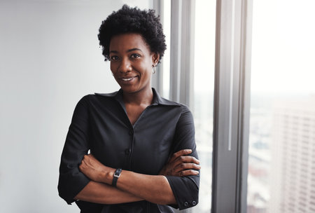 Success is for those who believe in themselves. Portrait of a professional businesswoman standing in an office.の写真素材