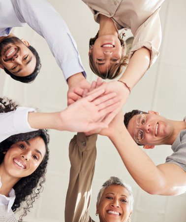 Hands stacked, teamwork and people portrait in support, collaboration or team building mission from below. Group, circle or business women and men, together hand sign and happy goals with diversityの写真素材