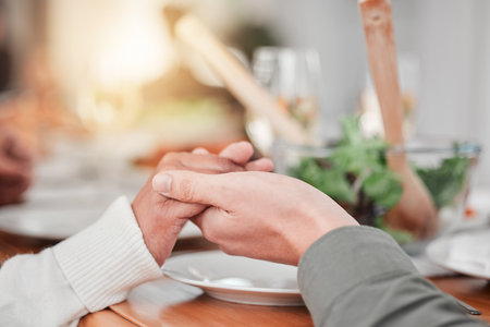 Family, dinner and party, hands together for prayer, gratitude for food and love, celebration and holiday. Worship, thank God and relationship, hungry people with meal and social event or gatheringの写真素材