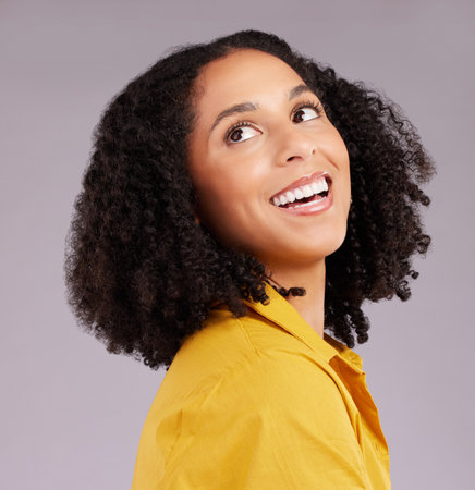 Woman, happy and thinking face in studio, background and backdrop for ideas, remember memory and mindset goals. Smile, female model and daydream of visionary thoughts, imagine and optimism of hopeの写真素材