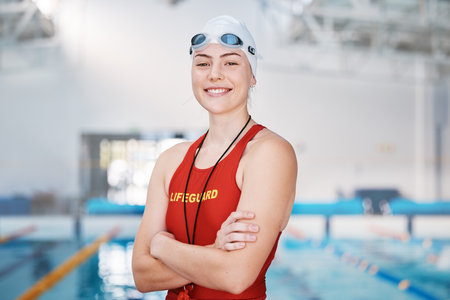 Swimming pool, lifeguard and portrait of woman with confidence and goggles at water for safety training exercise. Professional sports, life saving workout and swimmer at swim competition with pride.の写真素材