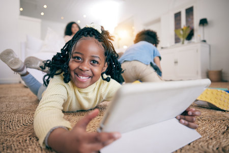 Relax, smile and portrait of black girl and tablet on floor of living room for elearning, streaming or education app. Technology, happy or internet with child browsing online at home for digital gameの写真素材