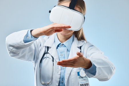 Vr, medical and holding with doctor and headset for augmented reality, healthcare and virtual analysis. Future, cyber and technology with woman and research for expert, medicine or science in studioの写真素材