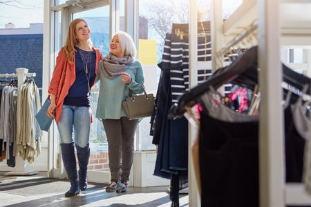 You always know the best places to shop at. a mother and daughter shopping in a clothing store.の写真素材