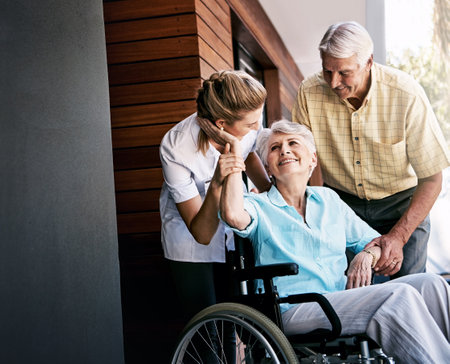 I appreciate your support so much, my dear. a senior couple and a nurse outside a retirement home.の写真素材