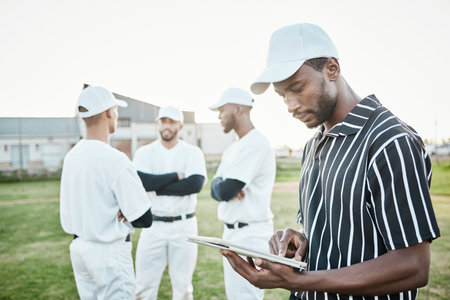 Black man, planning or baseball coach with a strategy, training working or softball game field formation. Teamwork, tablet or leadership with sports men or athlete group for fitness or mission goalsの写真素材