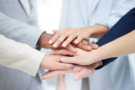 Success, teamwork and hands of business people in office for community, diversity and support. Solidarity, winner and collaboration with group of friends for goals, motivation and celebrationの写真素材