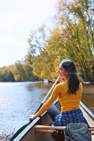 Loving life out on the water. a young woman going for a canoe ride on the lake.