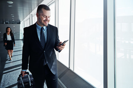 two executive businesspeople walking through an airport during a business trip.の写真素材