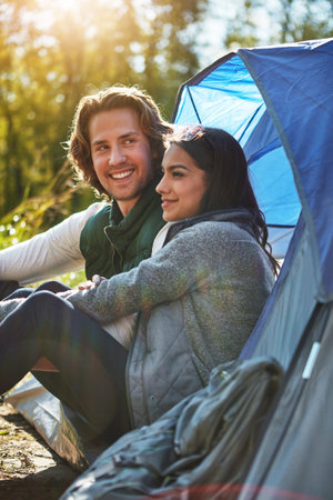 an adventurous young couple at their campsite.の写真素材