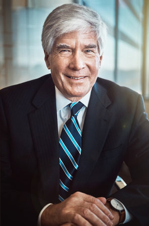 Cropped portrait of a mature businessman working in his office.の写真素材