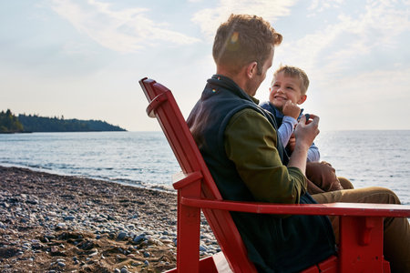 My little bit of perfect. a handsome young father and his son enjoying a day by the lake.の写真素材