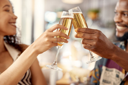 All smiles when theyre together. a young couple toasting with champagne in a restaurant.の写真素材