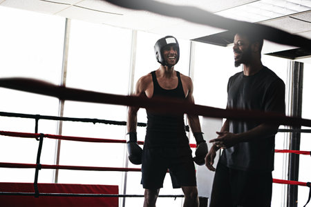 Its not all seriousness in the boxing ring. a man training in the boxing ring with a coach.の写真素材
