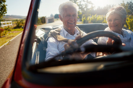 Our happiness is the only thing that matters now. a senior couple going on a road trip.の写真素材
