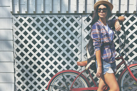 Just out for a leisurely ride. a beautiful young woman riding her bike in the park.の写真素材