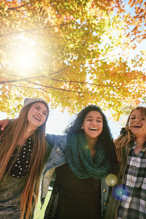 The best thing in life is having best friends. a group of young friends enjoying a day at the park together.の写真素材