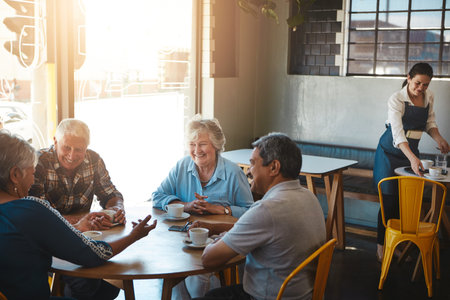 Friendship gets better with age. senior couples on a double date at a cafe.の写真素材