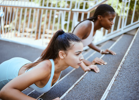 Push ups, personal trainer and women workout on bridge for outdoor training or accountability. Wellness, fitness and strong athlete people exercise together for healthy lifestyle goal and supportの写真素材