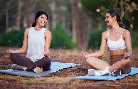 Meditation, nature yoga and women exercise outdoor for fitness, peace and wellness. Friends on forest ground laughing for lotus workout and energy for mental health, chakra and zen mind or timeの写真素材