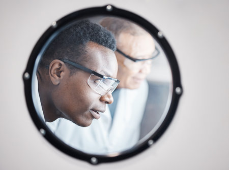 Science, research and black man in laboratory incubator window for experiment, study and medical test. Healthcare mockup, biotechnology and male scientists with concentration for sample storageの写真素材