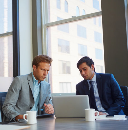 Meeting of the minds. businessmen working in their office.の写真素材