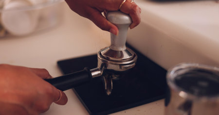 Hands, coffee press and filter for espresso to start morning for energy in home, kitchen or cafe. Woman, ready or preparation for drink, matcha or plunger at barista job, restaurant or small businessの写真素材