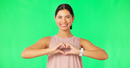 Heart, hands and face of happy woman on green screen for fitness, wellness or healthy life. Female...