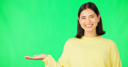 Happy woman, hand and green screen for product placement, advertising or marketing against studio background. Portrait of female face with smile showing advertisement or sale on copy space mockupの写真素材