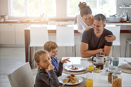 Building strong family ties. a family having breakfast together.の写真素材