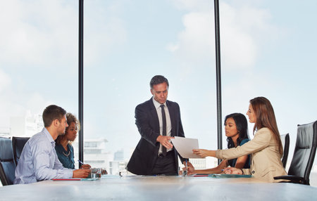The teams talking strategy. a group of businesspeople in a meeting.の写真素材